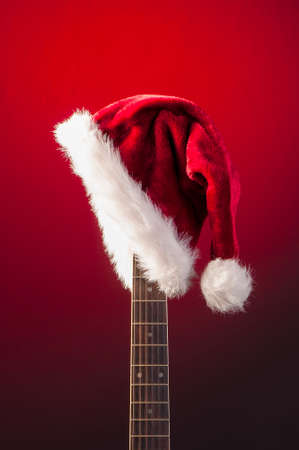 Red Christmas hat on guitarの写真素材