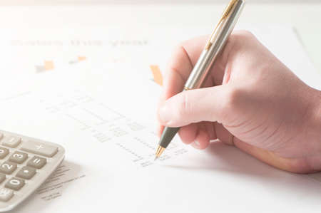 Financial data analyzing. Counting on calculatorの写真素材
