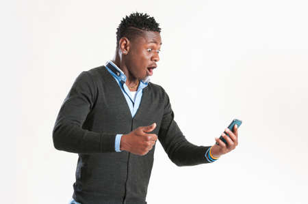 young african man surprised with his mobile phone