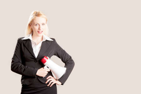 Young business woman with megaphone, over white backgroundの写真素材