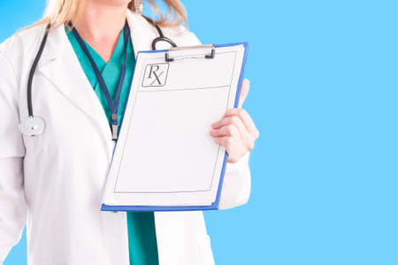 female doctor holding a clipboard with prescriptionの写真素材