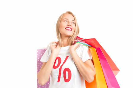 Portrait Of Young Woman Wearing perecentage symbol T-shirt Holding Shopping Bag in a Shopping Centre