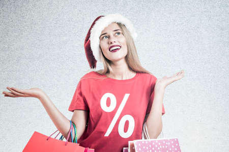 Santa woman holding colorful shopping bags with a percentage discount t shirt