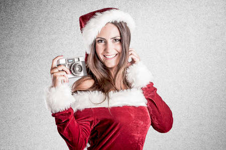 Santa girl with a retro cameraの写真素材