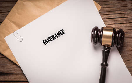 Insurance Policy document with court gavelの写真素材