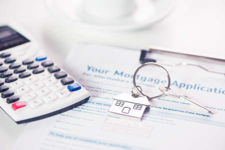 Mortgage loan agreement application with house shaped keyringの写真素材