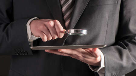 Businessman reading a contract on a tabletの写真素材