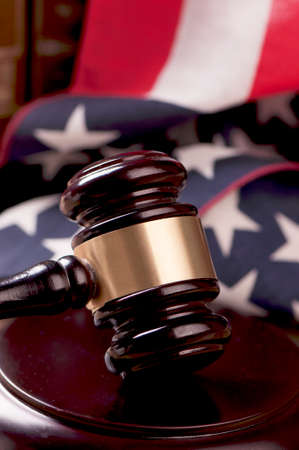 Judges wooden gavel with USA flag in the backgroundの写真素材