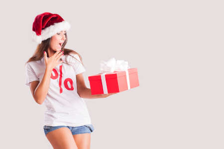 Beautiful young brunette woman with christmas gifts