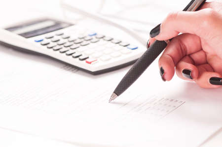 Accounting.Close up of a female hand with calculator