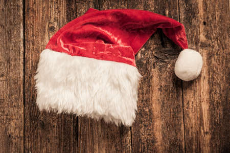 Santa red hat on wooden backgroundの写真素材