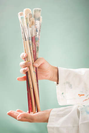 Artist holding paintbrushesの写真素材