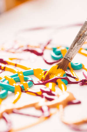 Close up of colorful paint and brushesの写真素材