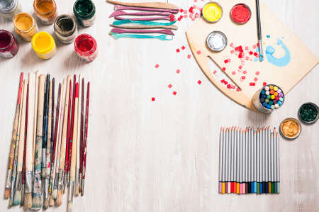Art suppllies, pencils, paints, brushes wiew from above