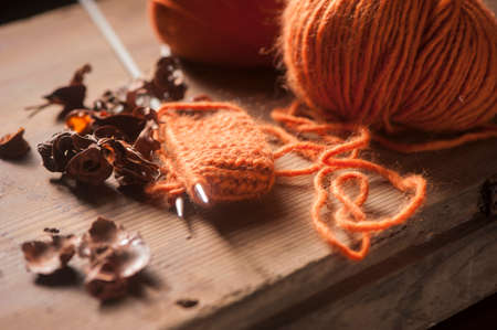 Orange woolen thread with knitted scarfの写真素材