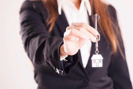 Real estate agent handing over house keysの写真素材