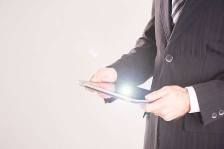 Young businessman in suit using tablet pcの写真素材