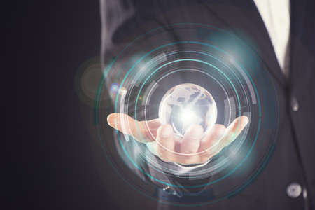 Businessman holds Earth in a handの写真素材