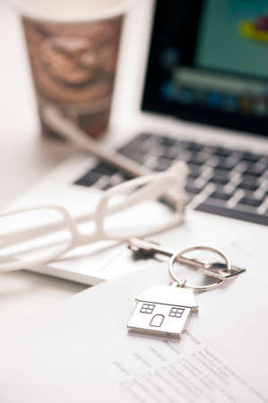 Coffe, laptop, croissants and contract with house keysの写真素材