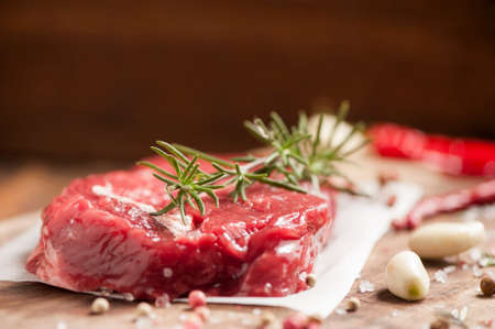 Fresh raw meat with salt, pepper and herbs