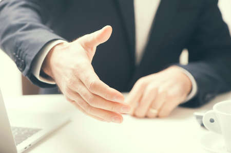 businessman extending hand to shake