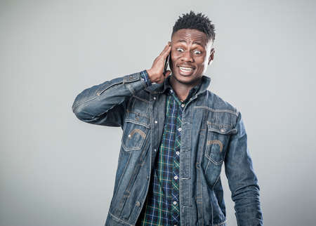 Afro american young man talking on the phoneの写真素材