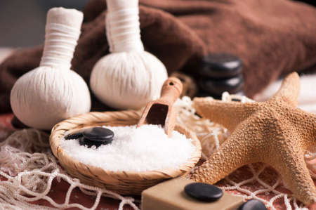 Spa massage with towel and herbal ballsの写真素材