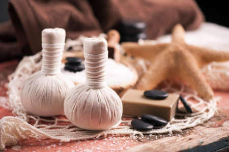 Spa massage with towel and herbal ballsの写真素材
