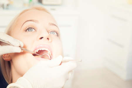 Dental cure. Molar treatment. Young female patient visiting dentist office.