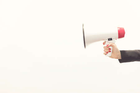 businessman's hand holding a megaphone isolated on white backgroundの写真素材