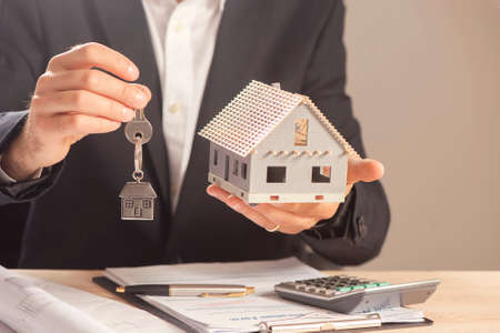 Real estate agent handing over house keys