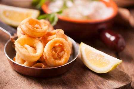 crispy calamari rings on wooden tableの写真素材