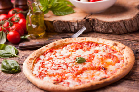 Italian Pizza on rustic wooden tableの写真素材