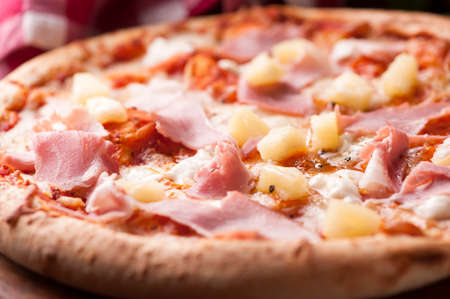 Wood Fired Gourmet pizza with a topping of Ham and Pineappleの写真素材