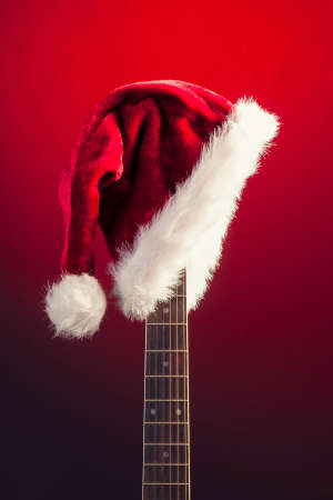 Red Christmas hat on guitar の写真素材