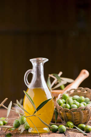 Olive oil and olives on wooden rustic tableの写真素材