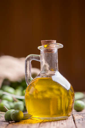 Olive oil and olives on wooden rustic tableの写真素材
