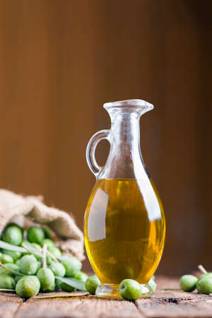 Olive oil and olives on wooden rustic tableの写真素材