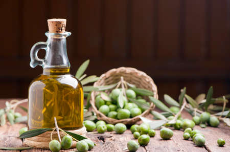 Olive oil and olives on wooden rustic tableの写真素材