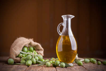Olive oil and olives on wooden rustic tableの写真素材