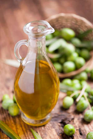 Olive oil and olives on wooden rustic tableの写真素材