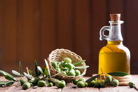 Olive oil and olives on wooden rustic tableの写真素材