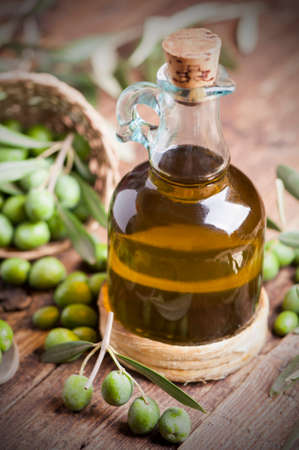 Olive oil and olives on wooden rustic tableの写真素材