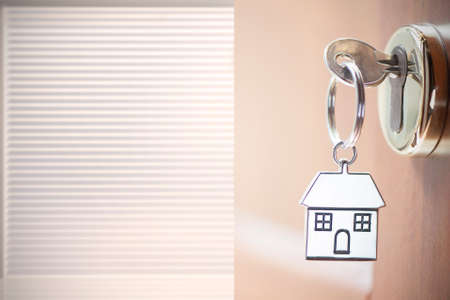House key in the doorの写真素材