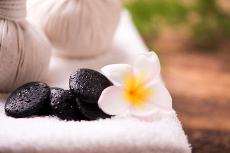 Spa stones with towel and plumeria