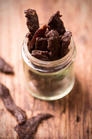 Beef Jerky on wooden backgroundの写真素材