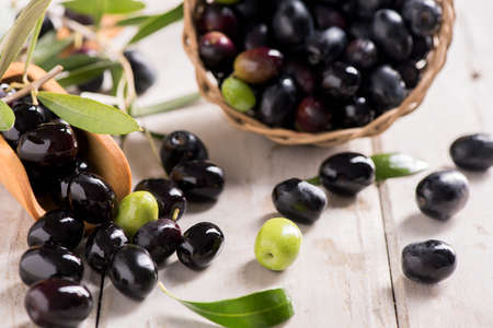 Black olives on a white tableの写真素材