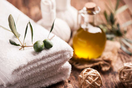 Olive oil bar soap with towels on wooden backgroundの写真素材