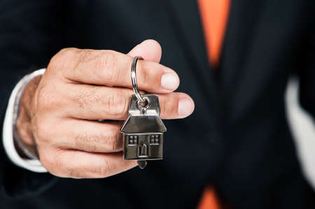 Real Estate Agent Handing over an house key. New concept Houseの写真素材