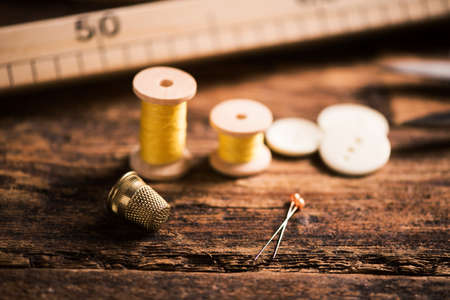Sewing tools on wooden tableの写真素材